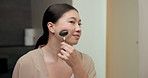 Skincare, massage or asian woman with jade roller in bathroom for anti aging treatment in home. Female person, relax or facial with cosmetic beauty tool for lymphatic drainage or circulation in house