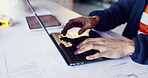 Architect, hands and typing on laptop for planning, design update or schedule for property development. Man, computer and engineer with blueprints for compliance regulations with maintenance research
