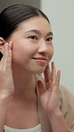 Skincare, results and Asian woman in mirror in bathroom for wellness, healthy skin and grooming. Reflection, home and happy person with face inspection for beauty, dermatology and glow for hygiene