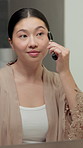 Woman, bathroom and jade roller for skincare in home with beauty, wellness or massage for circulation. Asian person, smile and dermatology with benefits for natural glow, self care or morning routine