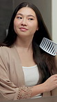 Happy, haircare and Asian woman in bathroom with brush, natural growth and frizz control for beauty. Smile, person and brushing hair in home with cosmetics, grooming maintenance and keratin treatment