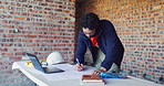 Writing, reading and man with blueprint at construction site, planning update or change for renovation. Engineering, remodeling or architect with revision of schematic, laptop or property development