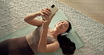 Woman, phone and headphones on floor, home and radio with audio, happy and relax for wellness. Asian person, sound and listen to music with exercise mat, mobile app and above with streaming at house