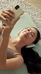 Relax, headphones or asian woman with phone for music, audio therapy or mindfulness above in home. Top view, female person or lying with smartphone, sound app or podcast for calm playlist in house