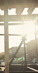 Building, structure and sunshine with scaffolding on construction site for civil engineering. Flare, metal and support with platform outdoor on worksite for property development or maintenance