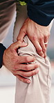 Hands, knee pain and injury in city at construction site with fatigue, joint ache and outdoor for job, Person, engineer or technician with legs, sore muscle or fibromyalgia with property development
