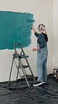 Woman, ladder and painting wall with brush for creativity, self expression and interior design. Process, person and home decor with diy project, remodelling and paint for renovation and inspiration