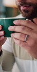 Man, hands and smell coffee on sofa with aroma in lounge for reflection, break and relax at house. Person, smile and perspective with beverage, caffeine or flavor on couch in living room of home