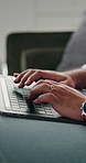 Hands, laptop and typing with man on sofa in home for planning, remote work or research. Agenda, computer and keyboard with person in apartment for feedback, report or review as freelance employee