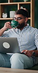 Coffee, laptop and remote work with man on sofa in home for planning, research or review. Computer, drink and schedule with happy person in apartment for feedback or report as freelance employee