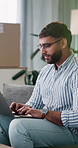 Laptop, remote work and typing with man on sofa in home living room for digital planning or research. Agenda, computer and review with freelance employee in apartment for online feedback or report