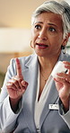 Doctor, pills and woman with instruction for healthcare, prescription and dose in hospital. Medicine bottle, talking and mature worker with drugs, explain treatment plan or medical advice in clinic