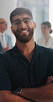Arms crossed, face and glasses with happy man in office for artistic career as creative professional. About us, eyewear and smile of employee in design workplace for development or job satisfaction