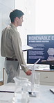 Businessman, presentation and screen in office with windmill, renewable energy or sustainable project. Person, talk and monitor in workshop with tablet, wind turbine or eco friendly power generation.