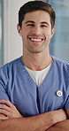 Face, nurse and happy man with arms crossed, healthcare and confident with medical career in clinic. Health professional, portrait and person with pride, laughing and wellness services in hospital