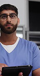 Healthcare, tablet and walking with man in hospital at night for planning, report or research. App, medical history and thinking with nurse in dark clinic for assessment, diagnosis or digital review