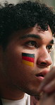 Man, suspense and watching tv with Germany flag for sports game, soccer contest or competition final. Flare, person and tension with live broadcast for football tournament, worry or anxious supporter