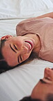 Couple, laughing and romance in bedroom, bonding and relax with partner on break or together in home. Love, connection and affection for spouse, rest and happy people on weekend and fun in house