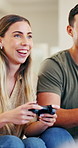 Competitive, couple and playing with controller, video game and tech for virtual sport, fun and web. Laughing, man and woman with console for challenge, gamer and happy in home with entertainment