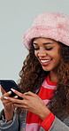 Texting, girl and laugh with phone in studio for funny celebrity gossip, social media meme and post. App, gen z person and happy with mobile on white background for comedy video, chat joke and humor