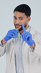 Science, face and man with beaker and smell with instruction, lab safety or tutorial. Biology, pharmaceutical and portrait of person with precaution for liquid, chemicals or test on studio background