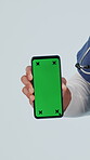 Doctor, hands and phone with green screen in studio, mockup space or wellness website recommendation. White background, medical professional and person with mobile, telehealth or healthcare marketing