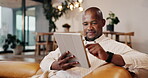 Man, scroll and relax with tablet in home, online and streaming movies with subscription on website. Happy, black person and watching film with tech, browsing and smile with entertainment in lounge