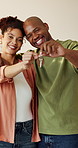 Face, key and smile of African couple in new home together for purchase or mortgage investment. Hug, property and real estate with happy people in apartment for financial security, growth or loan