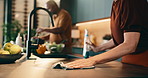 Cleaning, cooking and hands of couple in kitchen for help, meal prep and share tasks for marriage. Housework, counter and man with woman in home for disinfection, wipe or hygiene with food for dinner