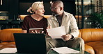 Documents, finance and tablet with interracial couple on sofa in home living room for planning. Budget, paperwork and technology with mature people in apartment for financial discussion or review