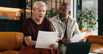 Documents, laptop and stress with interracial couple on sofa in home living room for debt or tax. Anxiety, computer and paperwork with mature people in apartment for financial argument or conflict