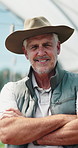 Man, face and arms crossed in greenhouse, farming and growth with sustainability in summer. Mature person, happy and portrait with food production, agriculture and nursery for vegetables in Canada