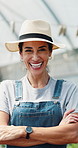 Woman, farmer and face in greenhouse with arms crossed, smile and hat with confidence in summer. Person, happy and organic farming with portrait, laugh or agriculture with sustainability in Spain