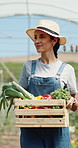 Happy woman, farmer and walk in greenhouse with basket, check and hat with organic produce in summer. Person, vegetables and farming with wood box, harvest and inspection for sustainable agriculture