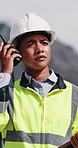 Construction, listening and woman with radio in city for update, communication and inspection. Rooftop, architecture and person with feedback for quality control, compliance report and maintenance