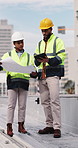 Construction, blueprint and people on tablet on rooftop for building inspection, meeting or planning. City, team and workers with tech, paper and discussion for engineering, maintenance or renovation