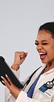 Medical, success or doctor with tablet, good news or patient recovery in treatment plan. Healthcare, woman or surgeon with fist pump, surgery progress or operation breakthrough on studio background