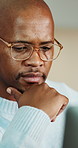 Thinking, black man and glasses in home with laptop, research and finance report for mortgage. Male person, eyewear and house with pc for email, review budget and loan application for household bills