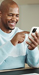 Phone, scrolling and black man in home with texting, chatting or social media on mobile app. Technology, happy and male person with cellphone for communication or email on website in apartment.