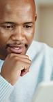 Smile, black man and reading in home with laptop, research and finance report for mortgage. Thinking, male person and house with pc for email, review budget and loan application for household bills