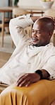 Smile, laptop and black man on sofa, home and internet for completed assignment, break and email. Apartment, happiness and African person on couch, excited and computer with routine and website info