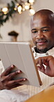 Online, scroll and man with tablet in lounge, home and watching movies with subscription on weekend. Black person, smile and streaming video with technology, browsing and entertainment in living room