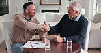 Senior, man and handshake with financial advisor in home for retirement plan, arrangement or deal. Elderly, male person or shaking hands with accountant for pension fund application or agreement