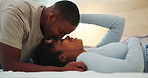 Smile, relax and couple in bedroom with kiss, love and partner affection for bonding together. Happy, black people and rest at house with admiration, romantic moment and comfortable for weekend break