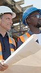 Blueprint, architect and team with men on construction site for contractor, remodeling update and vision. Discussion, engineer feedback and floor plan with people meeting for building inspection