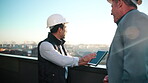 Construction, tablet screen and talk with men on rooftop for city planning or project management. App, hardhat and update with architect team outdoor for property, real estate or urban development