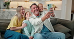 Parents, children and selfie in living room with smile, love and family bonding for social media post. Happy people, mother and father in home with girl kids, photography and online profile picture.