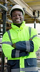 Crossed arms, happy and face of man on construction site, building project and renovation outdoor. Laugh, engineering and portrait of African person for infrastructure, development and architecture