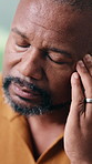 Headache, massage and black man with stress in home for mental health, overworked or strain. Frustrated, male person or migraine with sore muscle tension for vertigo, dizziness or pressure in house