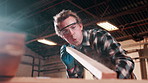 Carpentry, blow and man with sawdust in workshop for manufacturing, furniture repair and project. Factory, carpenter and person with gloves, dust and timber for woodworking, sanding and restoration